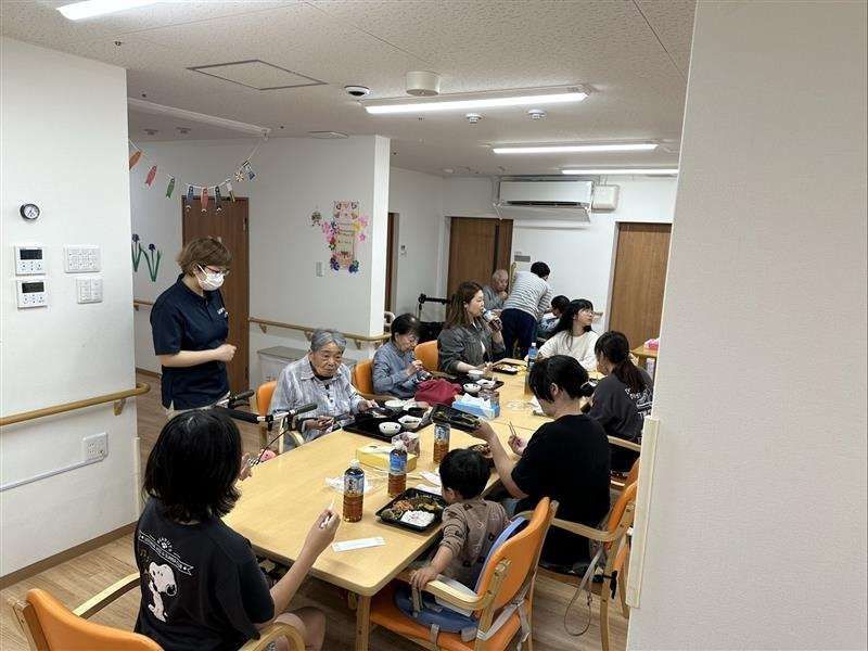 トイレや洗面所が付いたワンルームタイプのフローリングの部屋。大きな窓にはカーテンが付いていて、窓のそばにはエアコンがある。