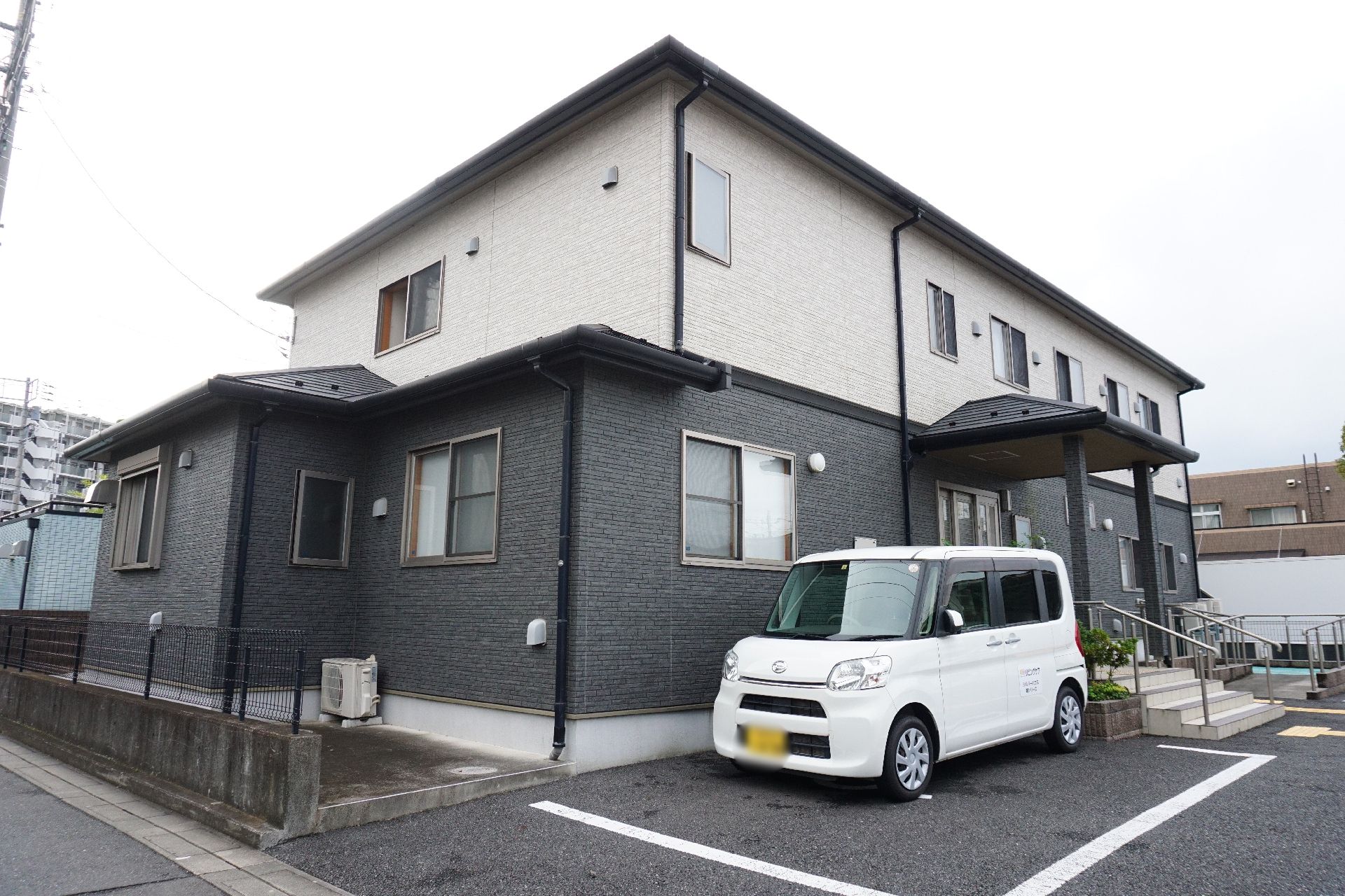 近隣に駐車場が設置されている介護施設の外観