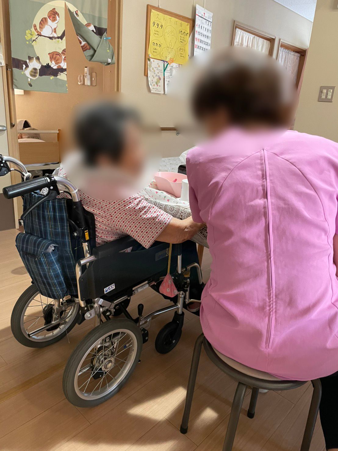 広い敷地内には落ち葉が落ちていて、それを集めている高齢男性がいる。男性のそばには大きな木があり、その後ろには和風の民家がある。