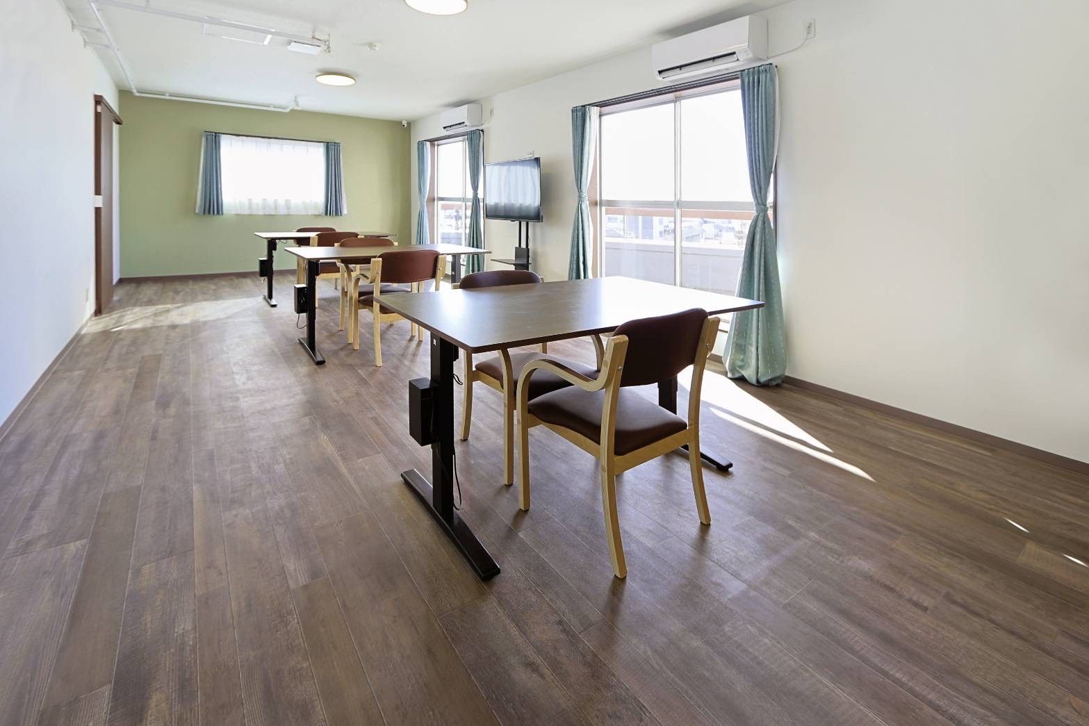 テーブルに椅子が置かれ、キッチンもある共有スペース