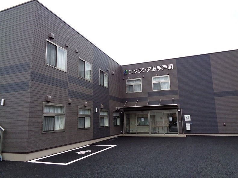 茶色と黒の外壁の2階建て建築物