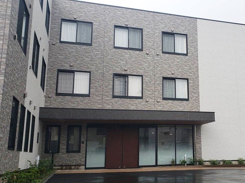 ツートンカラーの外壁の3階建て建築物