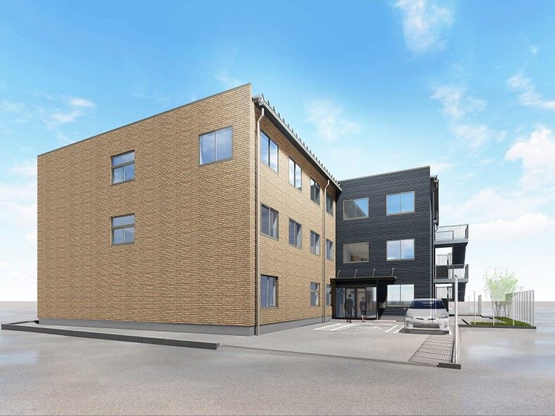 茶色と紺色のツートンカラーの外壁の3階建て建築物