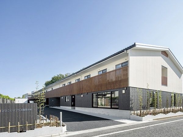 はなことばプラス練馬中村とかかれた看板がある2階建てで三角屋根の建築物
