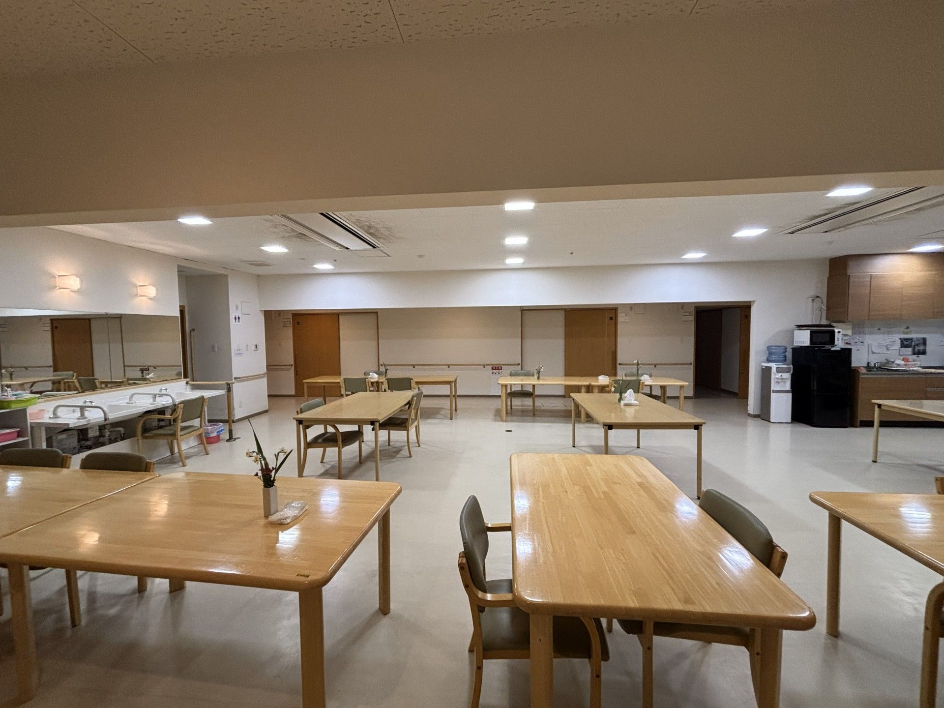 歩行訓練を行っている高齢者とそれをサポートするスタッフ2人