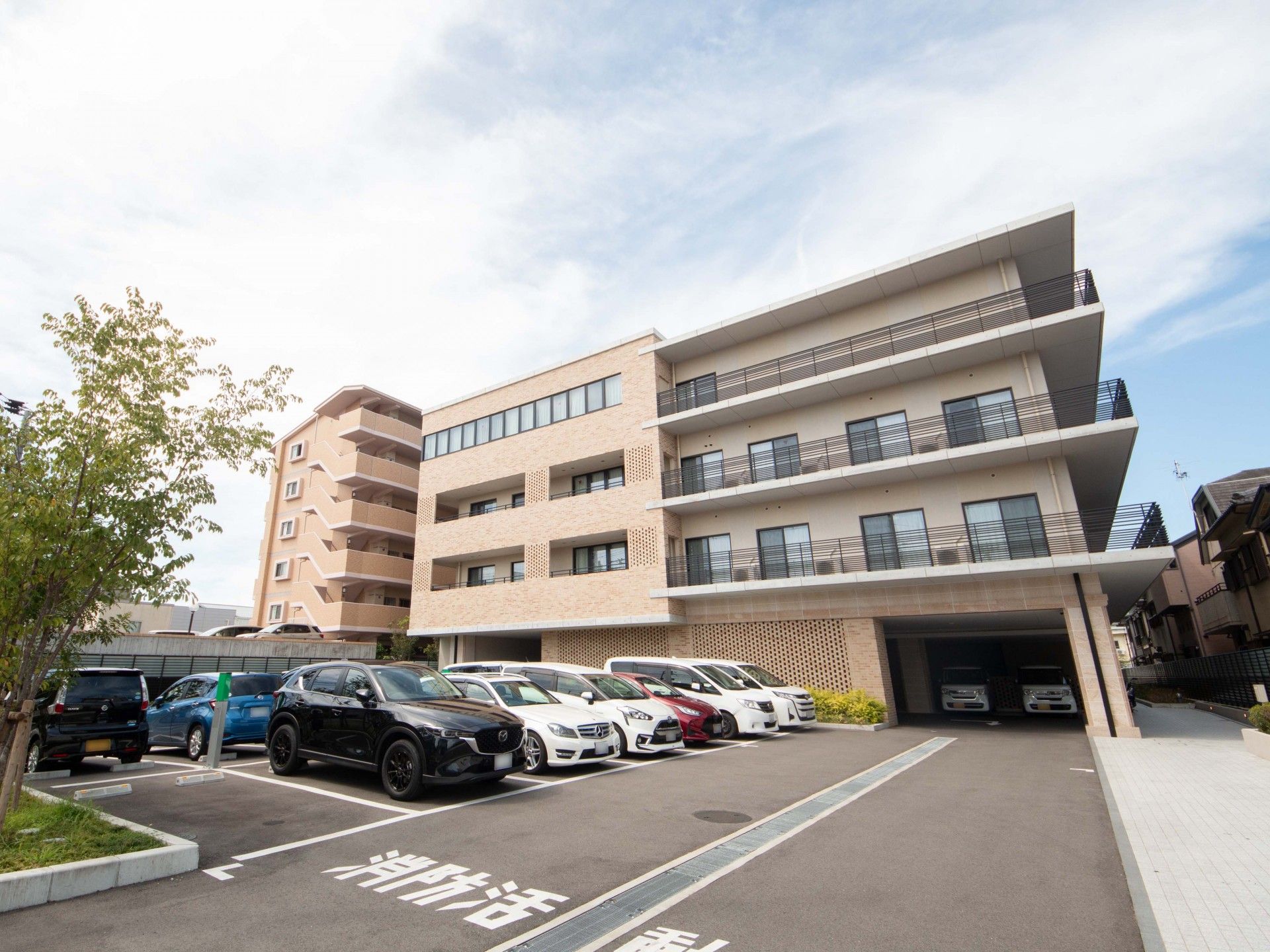 複数台のクルマと4階建ての建物