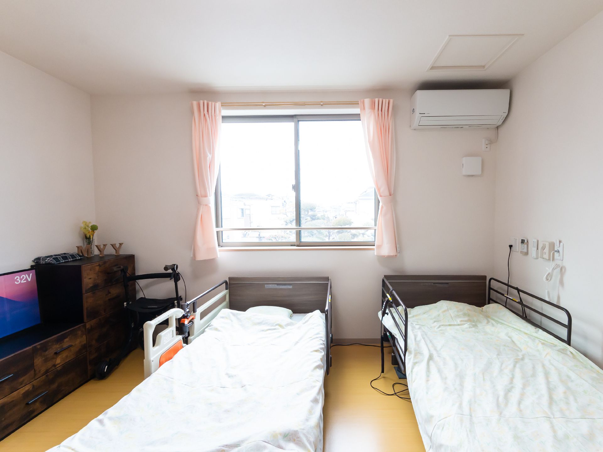 介護ベッドが二つ置かれている夫婦二人用の広めの居室