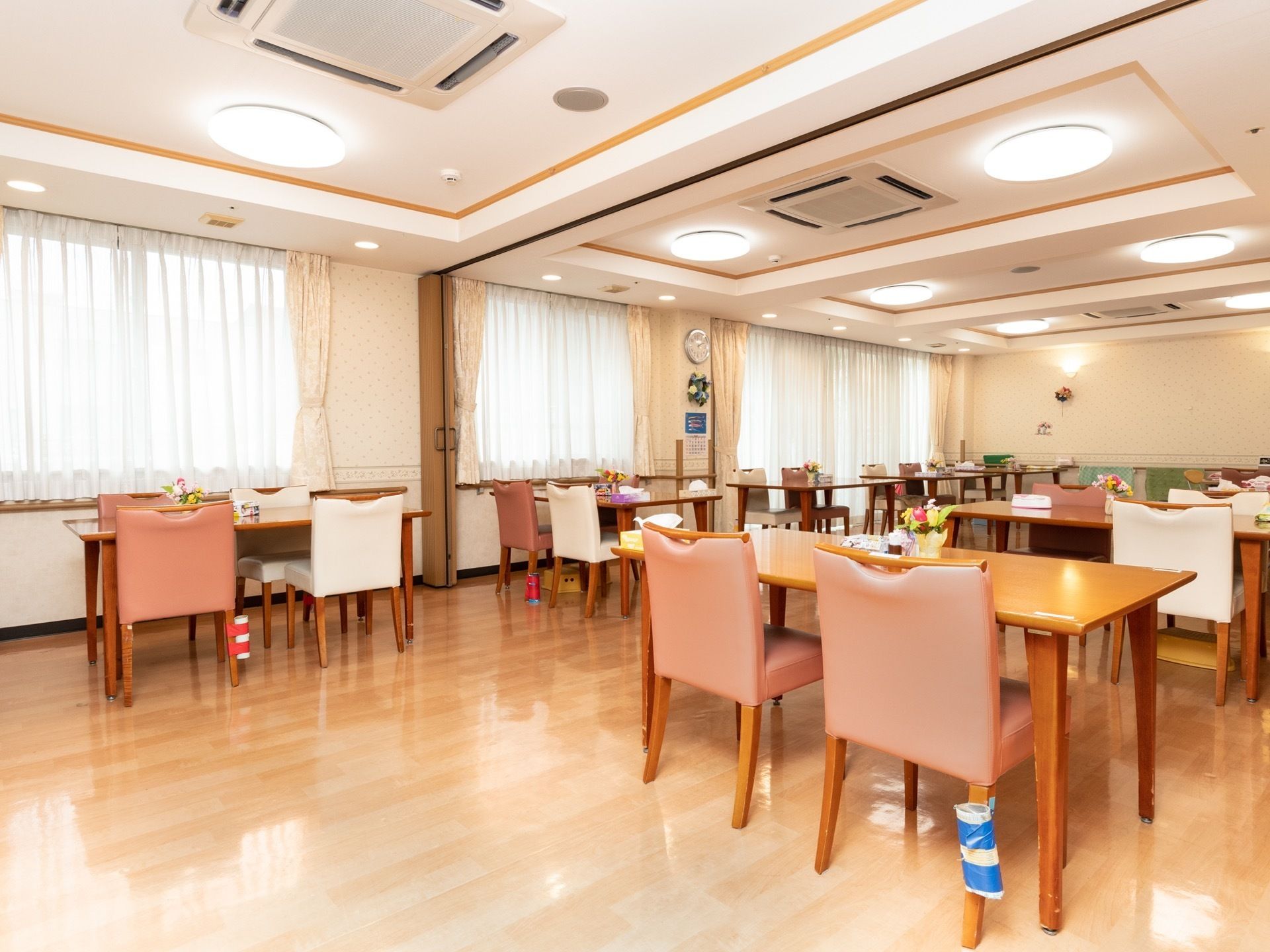 食堂は窓から日が入りとても明るい。内装も暖色系なので親しみやすい雰囲気で、入居者様が楽しく食事できるような空間になっている。