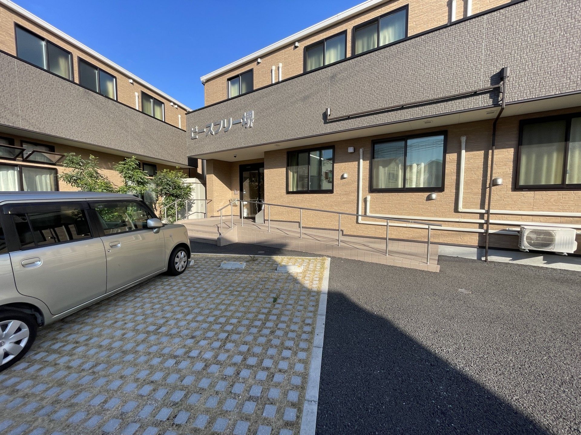 車いすに乗った男性とその人に話しかけている女性。家族で話している様子を写した写真