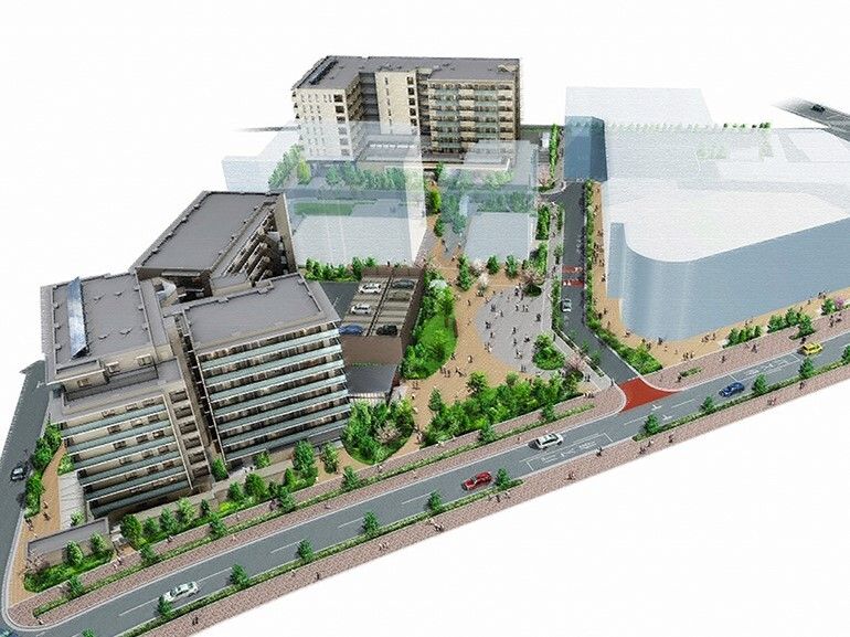 道路沿いにある一角には緑がたくさん植えられ、背の高いビルが複数建てられている。