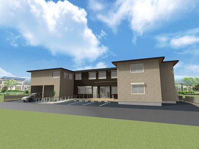 駐車スペースが付いた2階建ての建物。コの字型で玄関からは手すり付きのスロープが続いている。