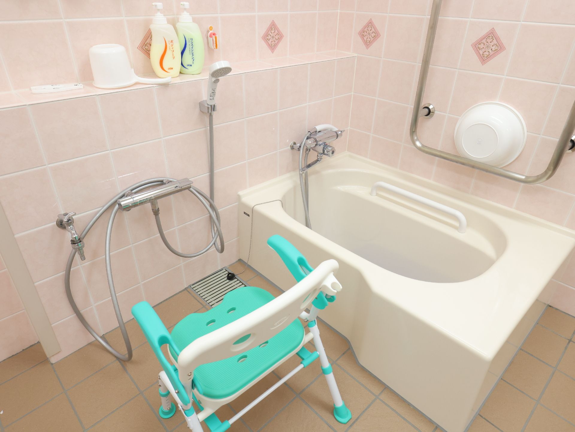 滑りにくい床材を使用し、壁に手すりが設置されている浴室