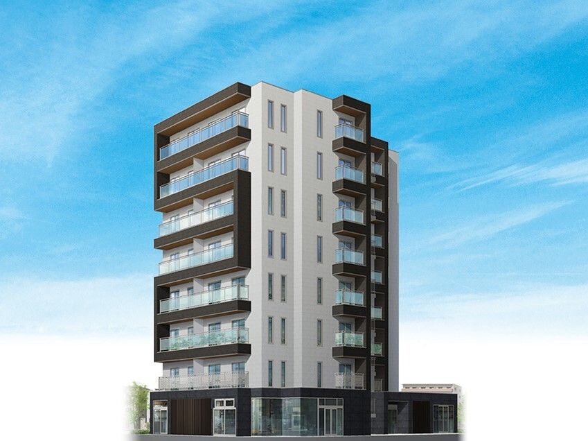8階建ての建物は縦に長く、1階部分と各フロアのベランダ、屋外階段部分はダークブラウン。