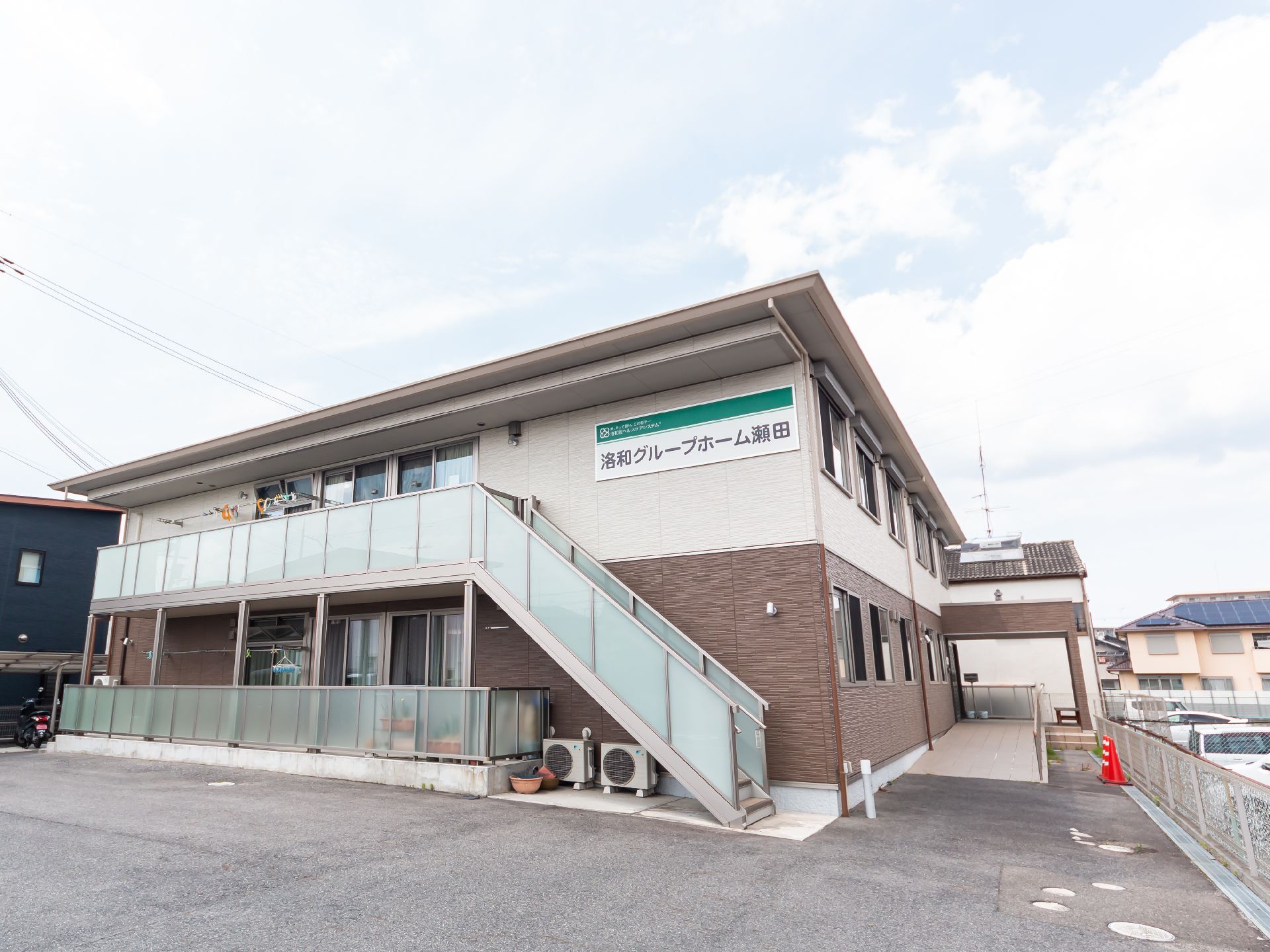 落ち着いた色合いで、駐車場も設置されている外観