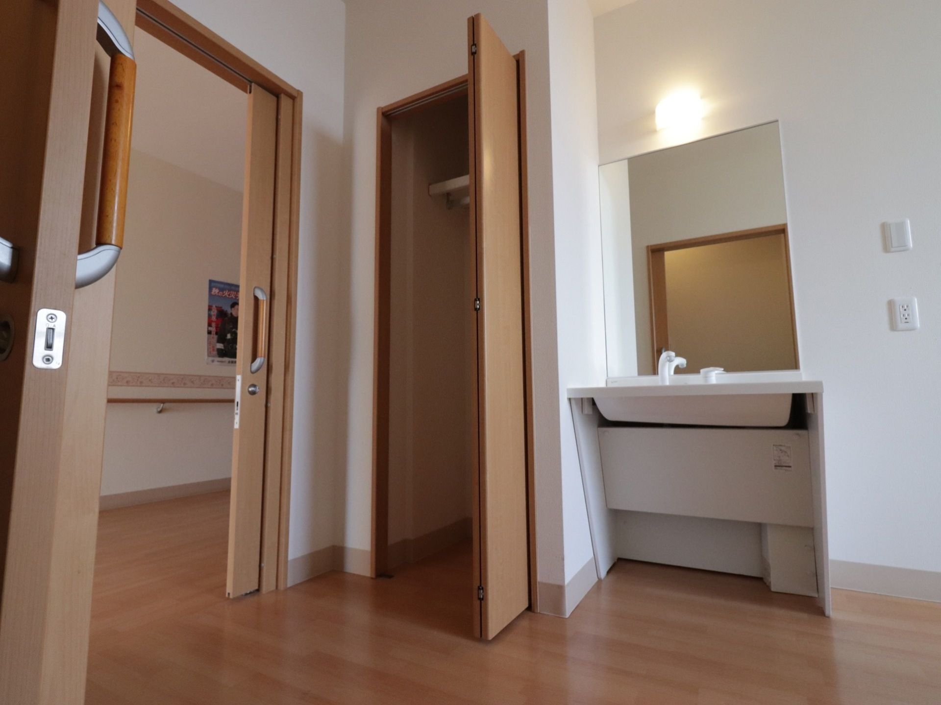 居室に備え付けのシンプルで入居者様が使いやすい洗面台と、洋服などを掛けて入れることができるクローゼットがある。