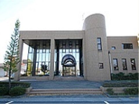 エントランスにはアーチ型の屋根が付いている。敷地や建物の周囲には木などの植物が植えられ緑に囲まれている。
