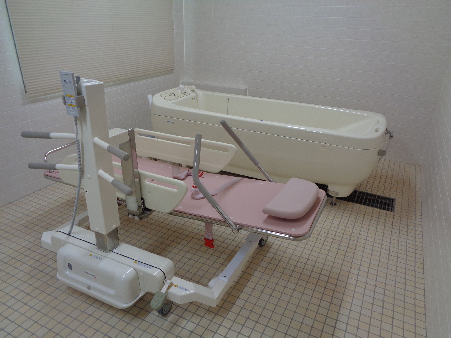 歩行訓練を行っている高齢者とそれをサポートするスタッフ2人