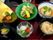 ぶりの照り焼きや炊き込みご飯、野菜の書きあげ、ミニトマトの和え物、吸い物などが並んだトレー。