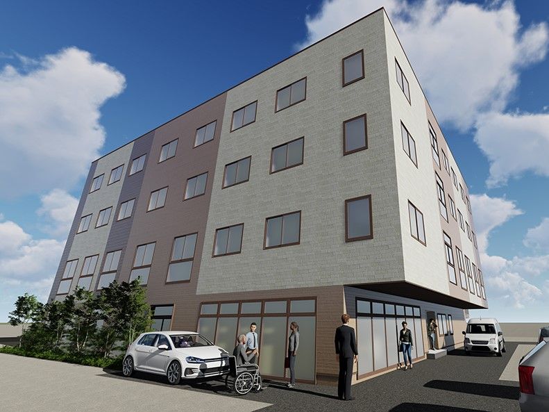 アイボリーと薄茶、薄紫の外壁の4階建て建築物