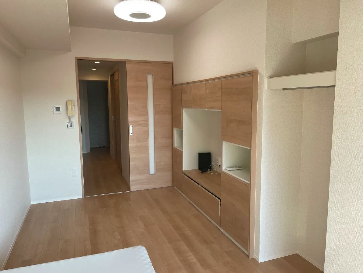 笑顔で拍手をしながら何かを鑑賞しているショートカットの高齢女性とポロシャツを着た女性スタッフ。