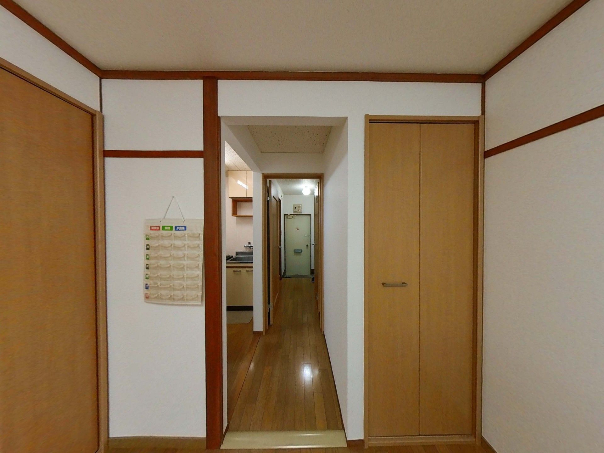 ストライプ柄のシャツを着た高齢男性が福祉車両から降りようとしているところを手伝っている若いスタッフ。