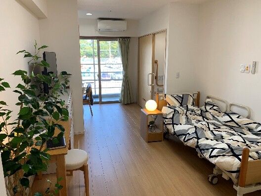 観葉植物や空気清浄器の置かれたロビーの一角には、可愛らしい丸テーブルがある。テーブルの上には一輪挿しが飾られている。