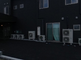 黒い外壁の丸い建物と周囲の風景