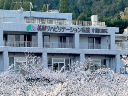 桜に囲まれた建物外観