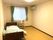エアコンが設置された部屋にはレースカーテンとカーテンが付いた窓や寝具付きのベッドが置かれている。