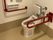 背もたれ付きの便座が付いたトイレは広く、両サイドに真っ赤な手すりが付いている。