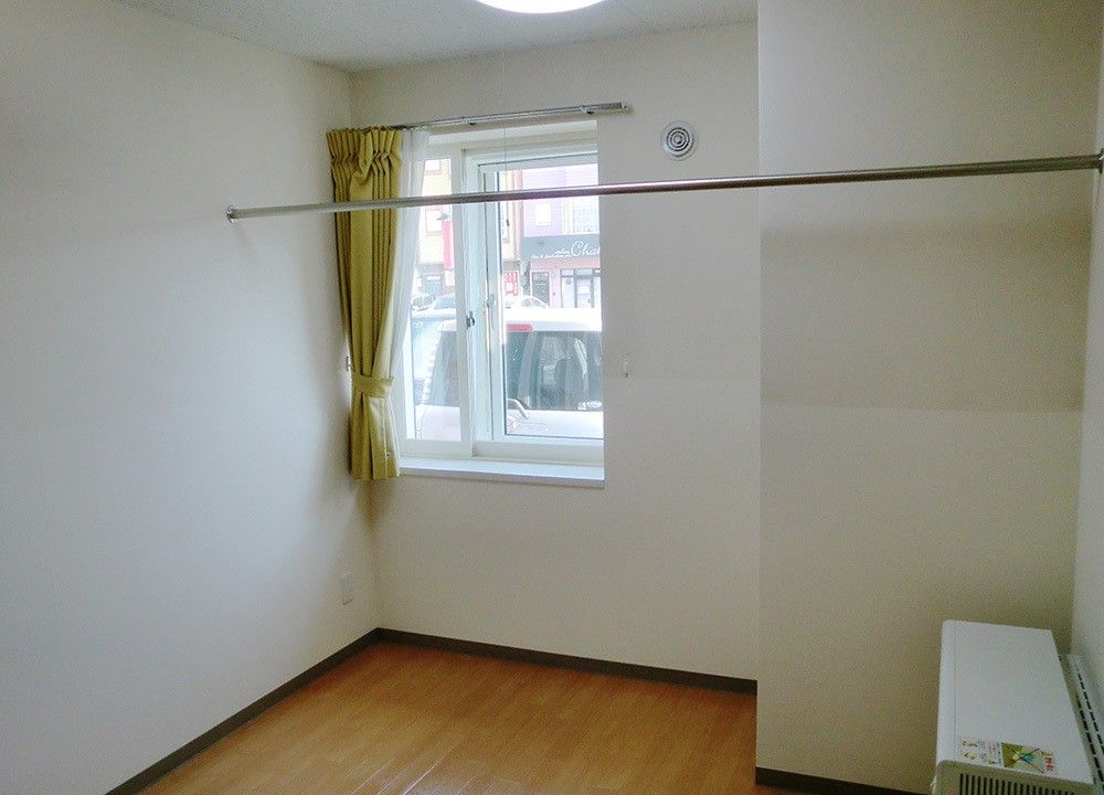 お部屋には照明、物干し、カーテンが設置されている。