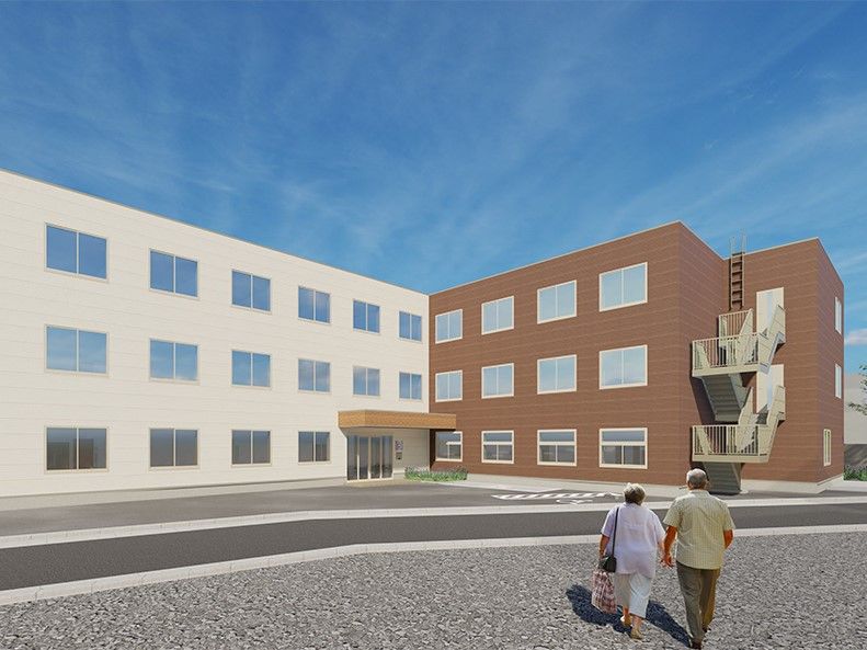 茶色と白の2色の外壁の3階建て建築物