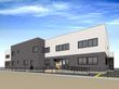 白黒ツートンカラーの外壁に、外階段やスロープが設置されている2階建て建築物。