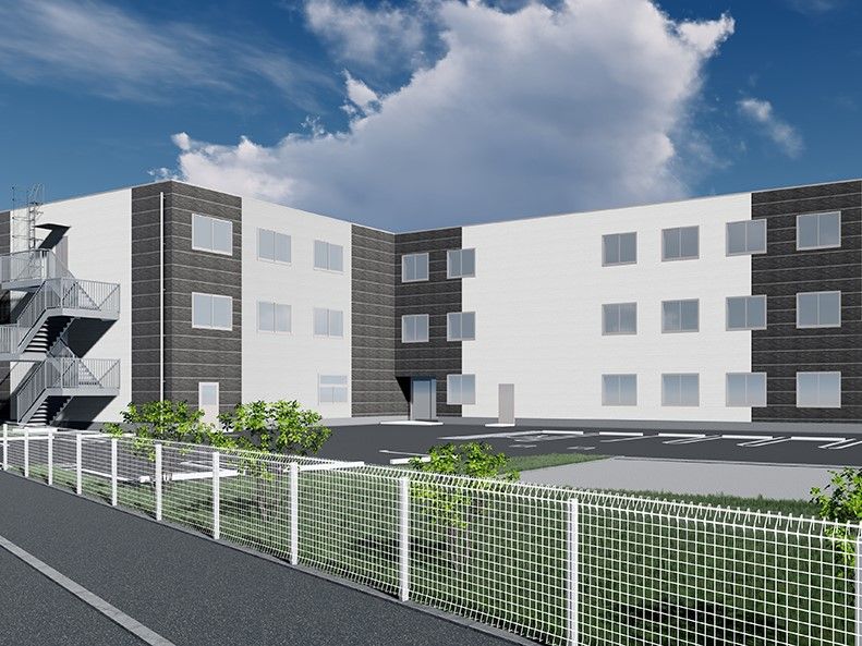白と黒ツートンカラーの外壁で横階段がある3階建て建築物