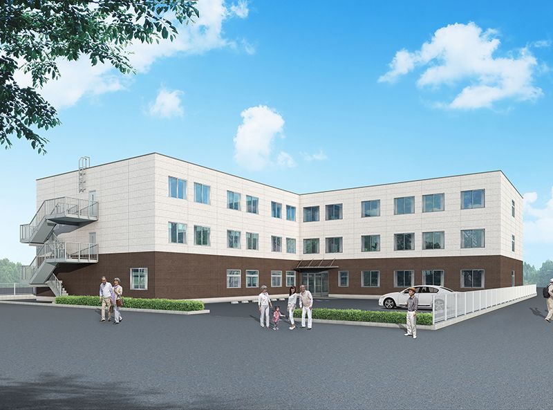 1階外壁が茶色、２～3階外壁が白の3階建て建築物