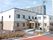 白とべ＾ジュの２階建ての建物は玄関に屋根があり、手すり付きのスロープが設置されている。