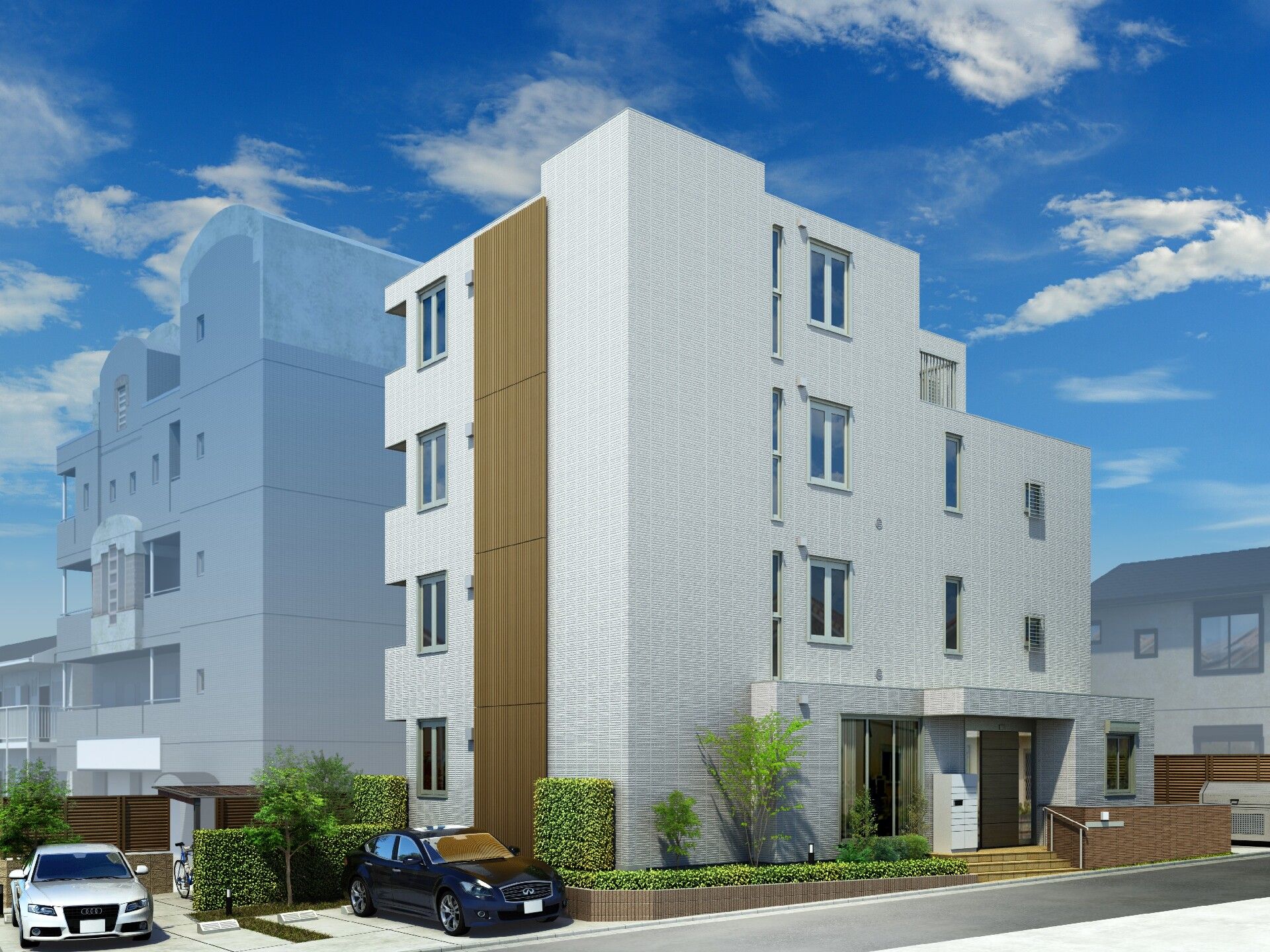 白を基調とした建物は３階建てで日当たりのいい場所に建っている。駐車場もあり、車も数台止まっている。