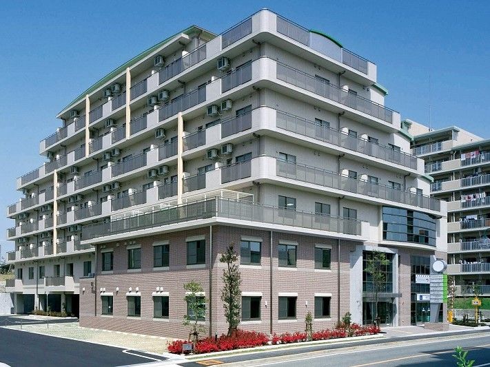 一部茶色い壁だが、大半が白い壁となっている7階建ての建物