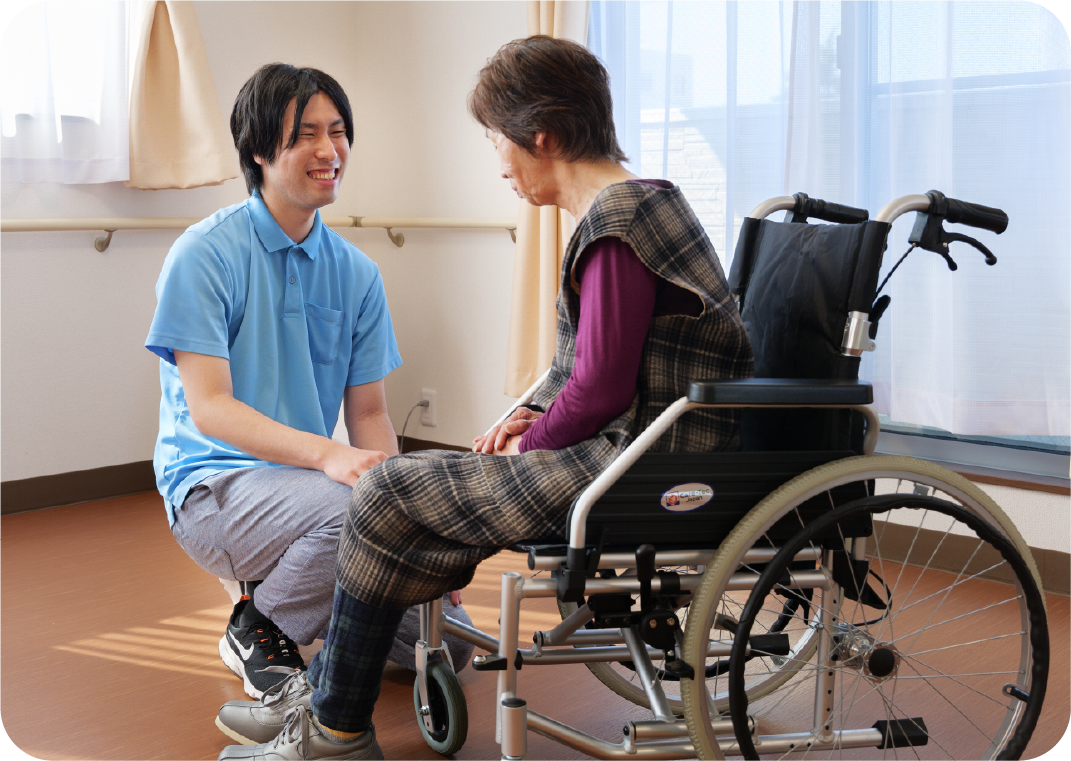 車いすの女性と2名の医療スタッフ