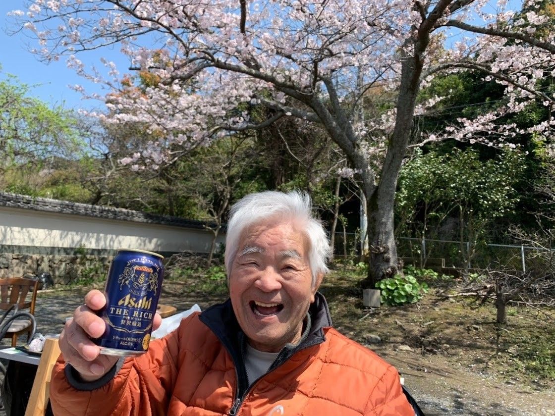 桜の下で笑顔の男性