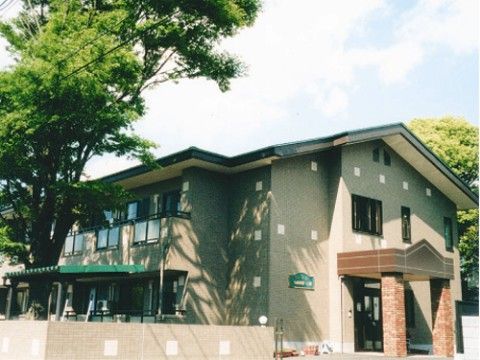 ペンションのような外観のお洒落なグループホーム。周りには大きな木もあり、木陰を作りだしている。自然に囲まれて心地が良い。