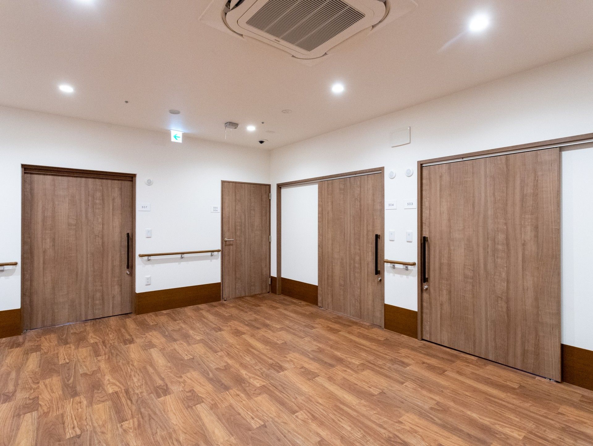 木目調の扉が並ぶ廊下