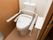 居室内に設置されて清潔感のある洋式トイレ。トイレの脇には動作補助のための手すりが取り付けられている。