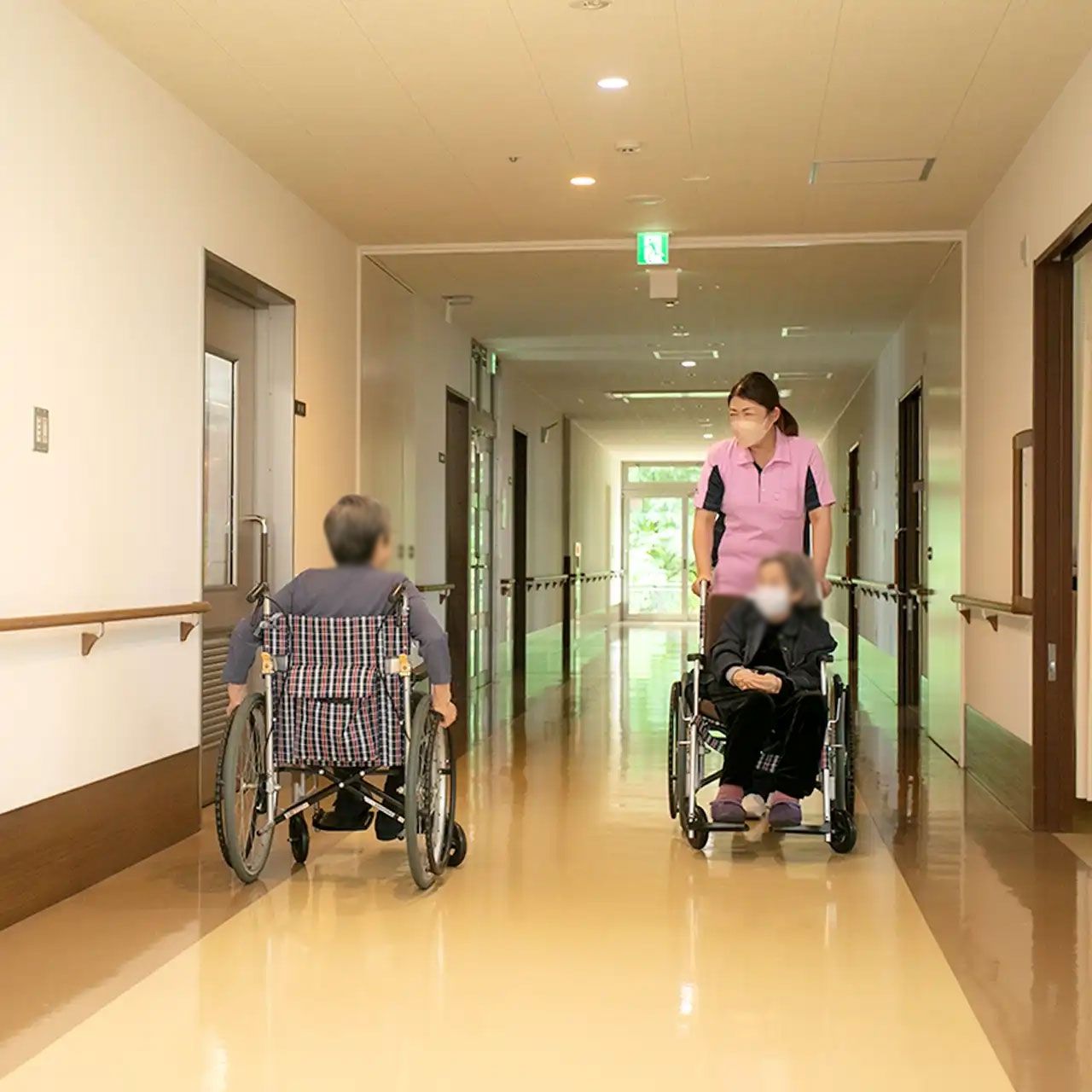車椅子の方と職員の廊下